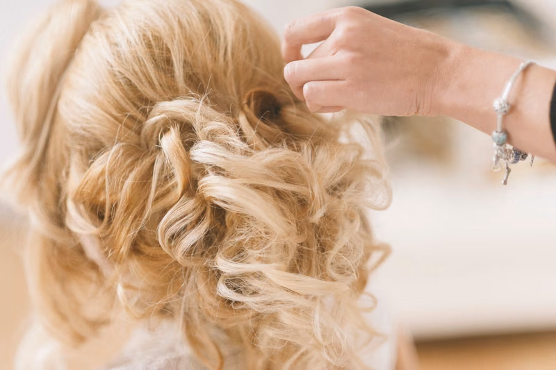 Pinned blonde curls in an updo, close-up